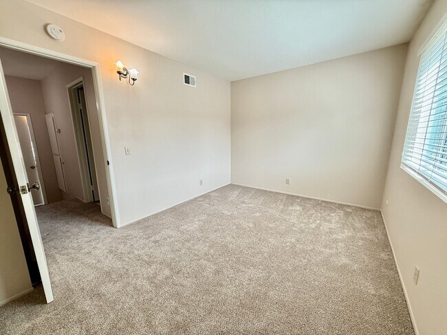 Building Photo - Move in Ready! 2BD Townhome! New Carpet! Two Patio Spaces! Attached Garage!