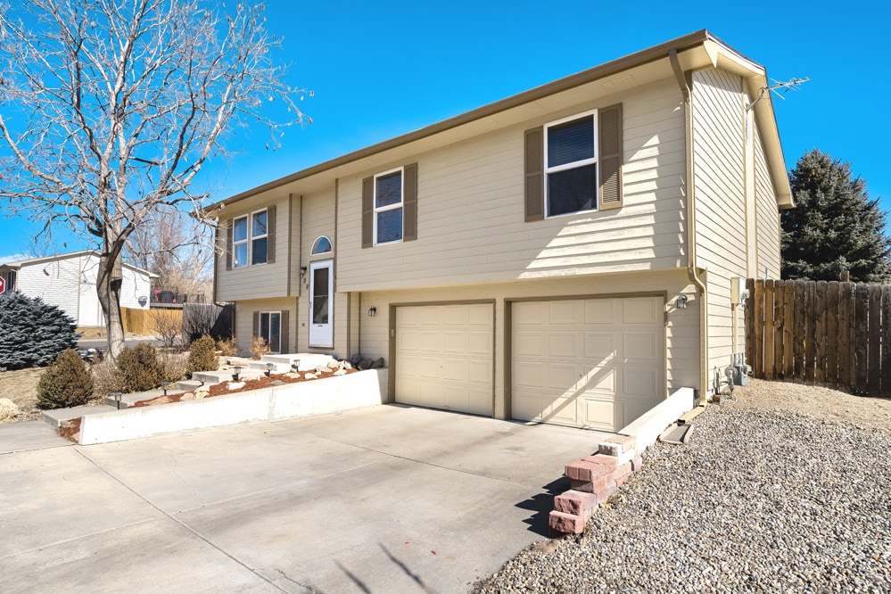Front of the house with gravel camper/boat/trailer storage - 500 Broadview Dr