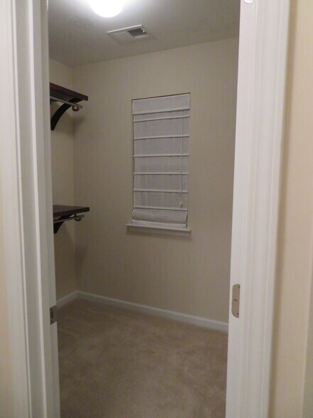 Master Suite Walk-In Closet/Dressing Room has a window over the front door w a Roman blind - 2496 Stadium Dr