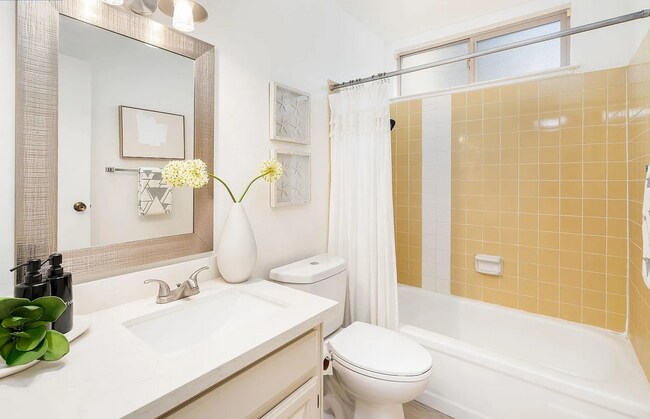 Building Photo - The updated bathroom offers a shower-over-...