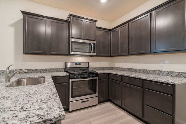 Building Photo - Super clean & spacious 4-bdrm/3-bath townhome in NE—Attached garage, great location