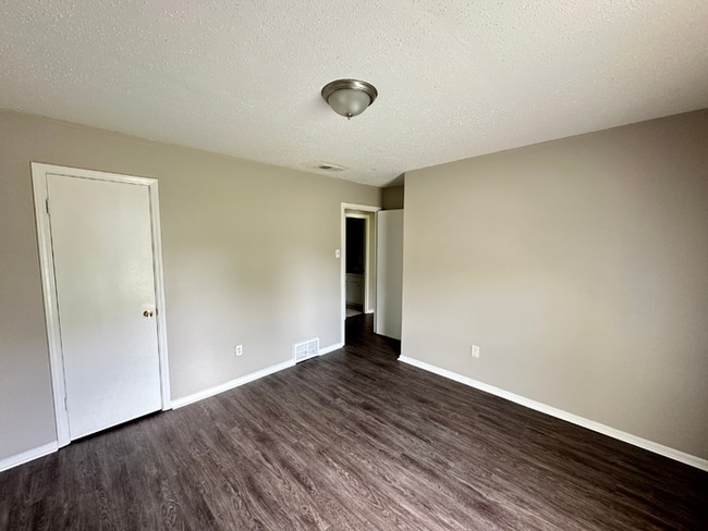 Building Photo - Charming 3BR/2BA Near Southwind | Soaring Vaulted Ceilings, Rustic Fireplace & Garage