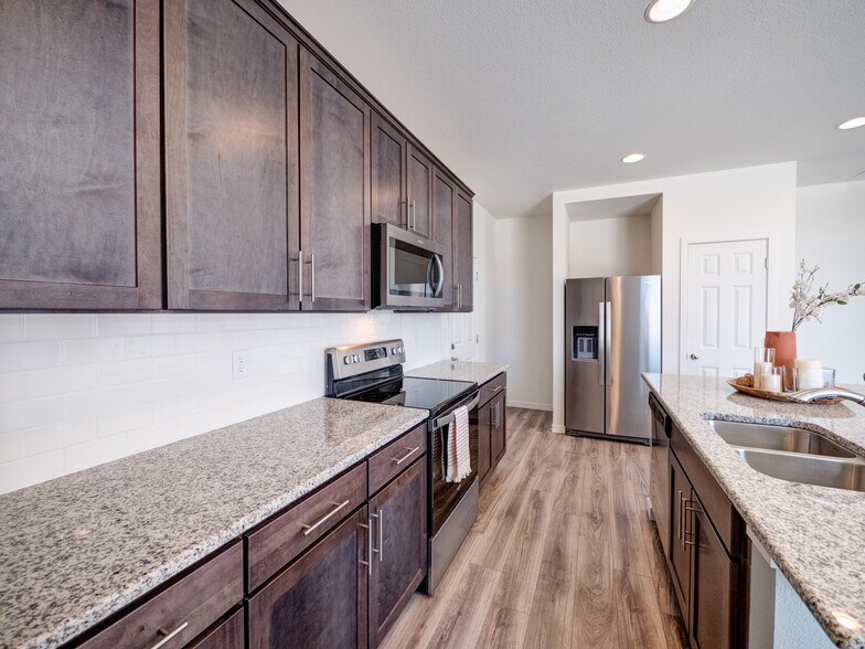 9278 Turlough galley kitchen has tons of storage and granite counterrops. - 9278 Turlough Hts