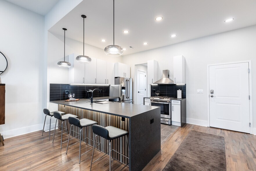 Spacious kitchen with large counter bar and waterfall quartz counter. - 795 E McMillan St