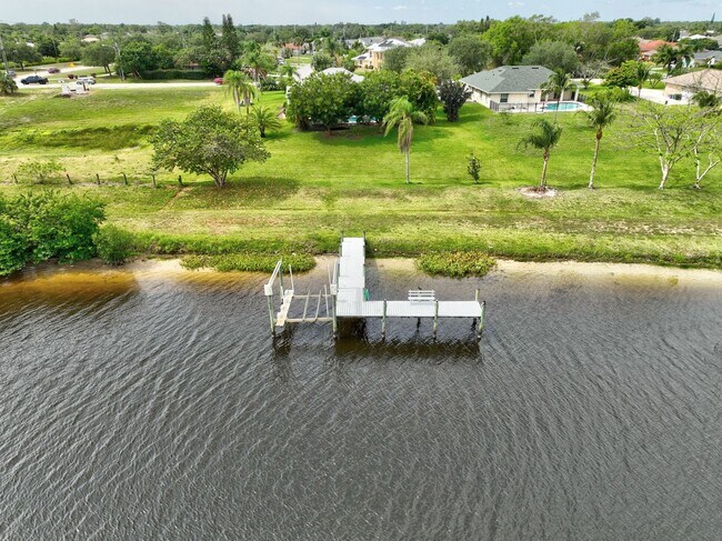 Building Photo - A BOATER'S PARADISE WITH THIS STUNNING 3 BEDROOM, 2 BATH WATERFRONT POOL HOME W/DOCK & BOAT LIFT ...