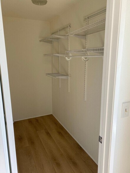 Large walk-in closet with built-in shelving - 8305 Summertime Ln