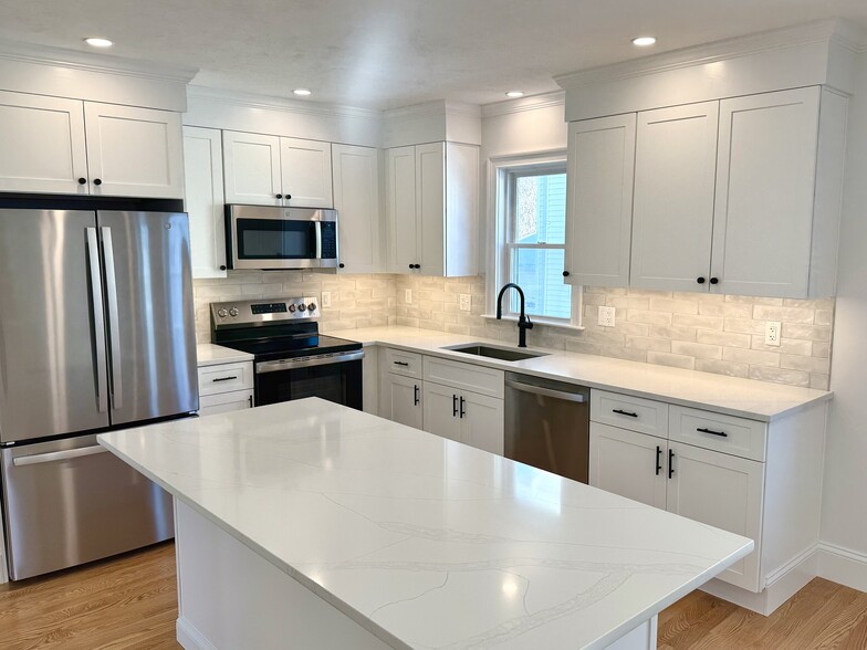 Kitchen: Brand New Stainless Steel Appliances, Quartz Countertops with Open Layout into Living Area - 34 Saint Joseph Ave