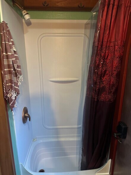 The tiny shower has a low-flow shower head and basic toiletries are provided. - 833 Valencia St