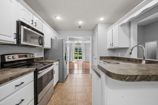 Building Photo - Stunning Stone Fireplace • Finished Basement • Fenced Yard
