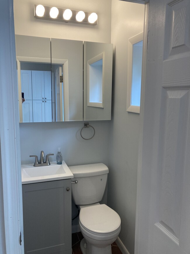 The efficient powder room features a window for natural light in addition to the vanity light to hel - 2621 E Somerset St