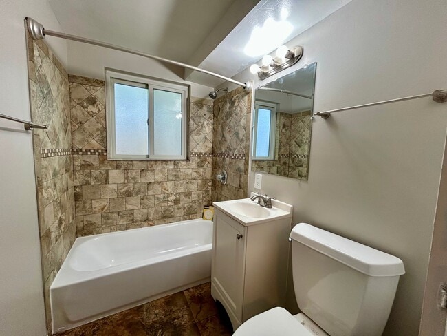 Chic bathroom featuring elegant tile work, a modern bathtub, and a stylish vanity for a soothing retreat. - Boardwalk Apartments
