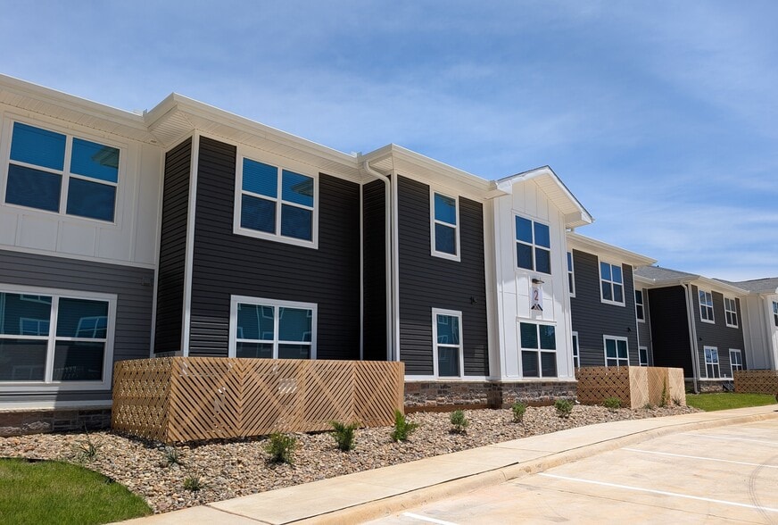 Modern Building Exterior with Professional Landscaping - Amber Meadows