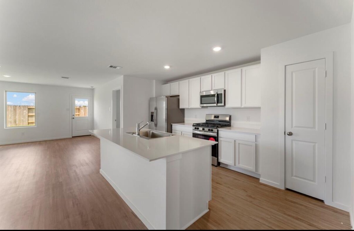 Island kitchen open to Family room Refrigerator included - 18602 Gravago Ln