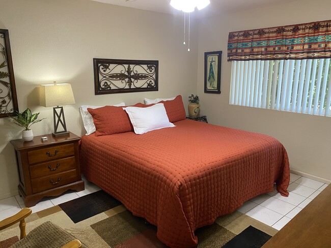 Master bedroom recently upgraded with a king-size bed and new bedding. - 10113 W Pebble Beach Dr