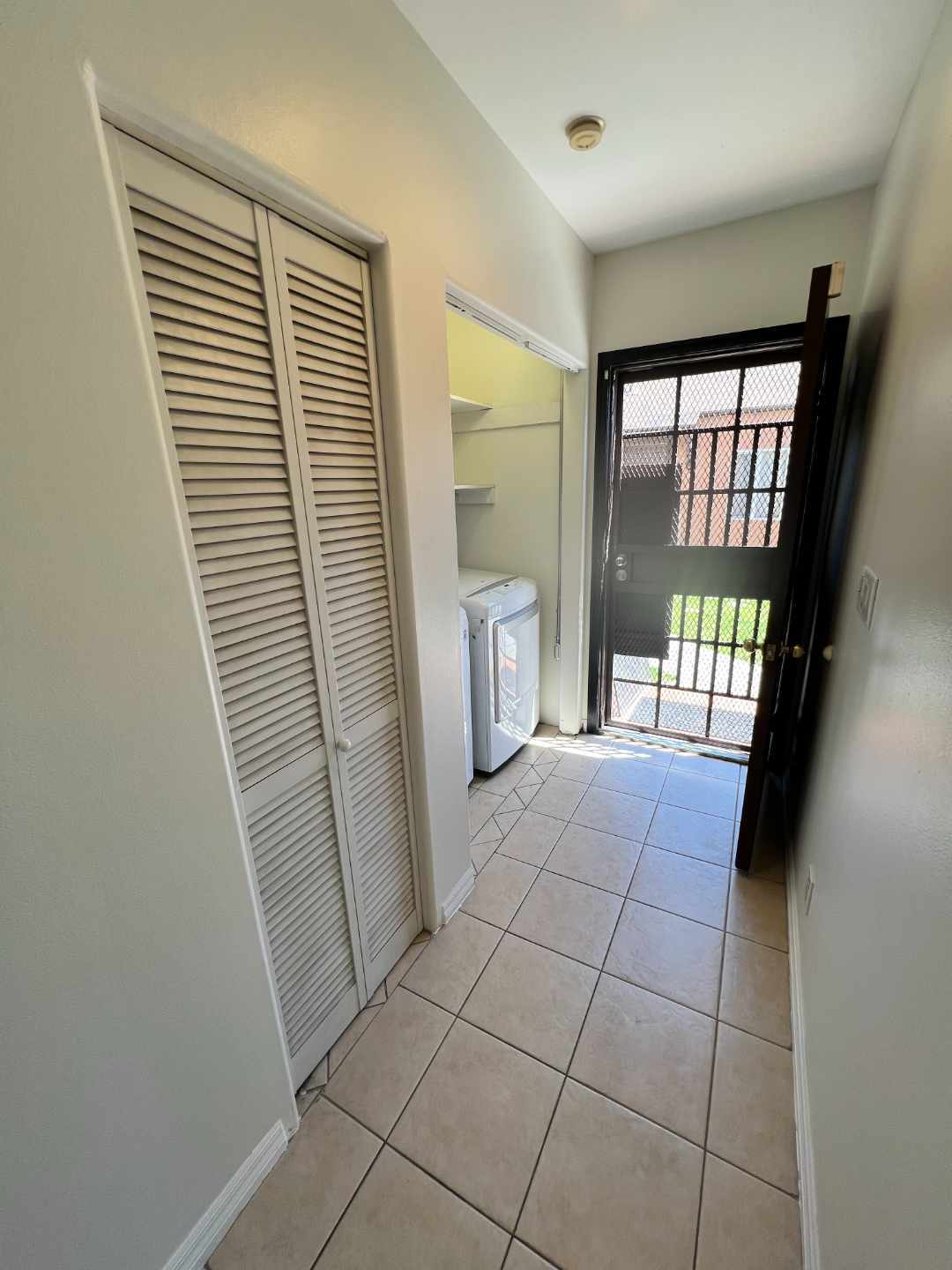 Utility/broom closet and washer/dryer service (wide-angle). Looking it to backyard with ADU. - 2330 S Mansfield Ave