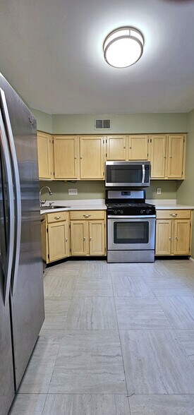 Generous Counter & Storage | Wraparound counters, a window over the sink, and upper-lower cabinets - 43 Tynemouth Ct