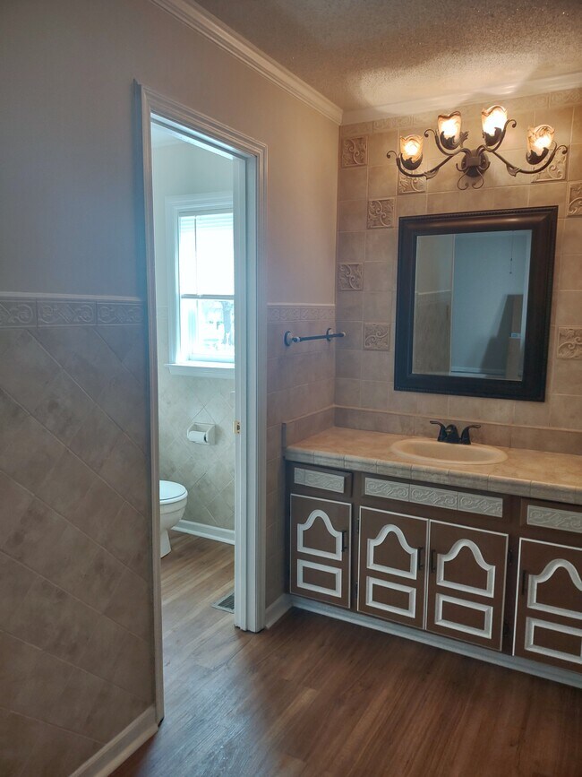 Master Bedroom vanity area and bathroom. - 120 Arrow Lands Trl