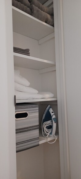 Linen closet stocked with towels and iron - 402 13th ST NE