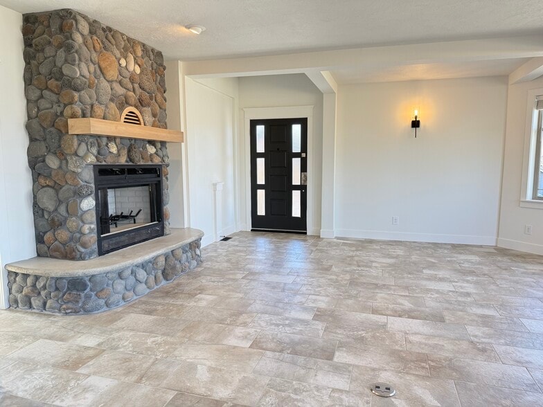 Living room, stone fireplace, front entry - 24 Ash St N