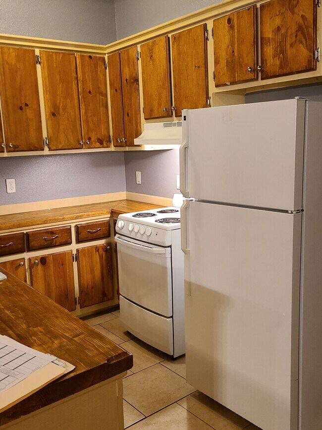 View of refrigerator, oven, and counter - 420 W Will Rogers Blvd