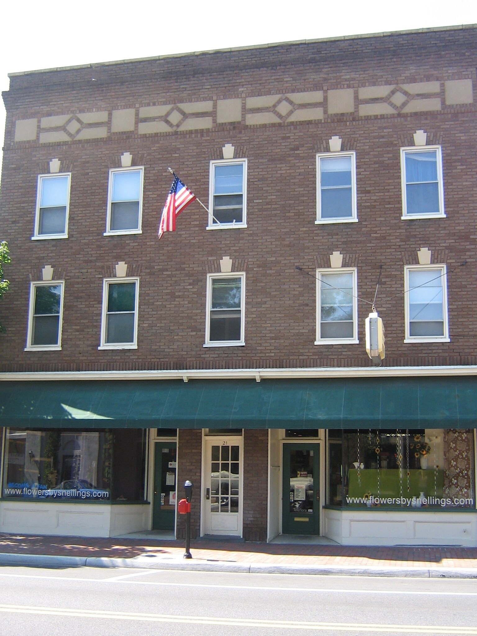 Front of building, white (now green) door is apartment entrance - 21 N Braddock St
