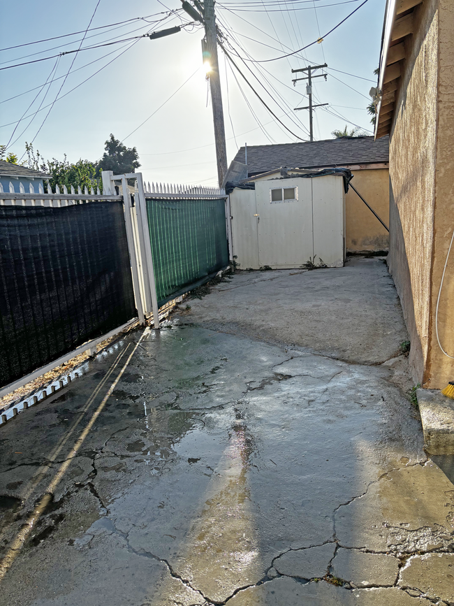 Space can be used as a patio or additional parking with included storage shed for use. - 1334 E 92nd St