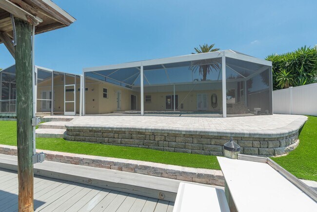 Building Photo - Live the ultimate Space Coast waterfront lifestyle at this stunning beachside canal home in Satel...
