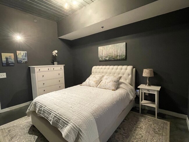 Bedroom with wall mounted smart tv & walk-in closet - 620 Glen Iris Dr NE