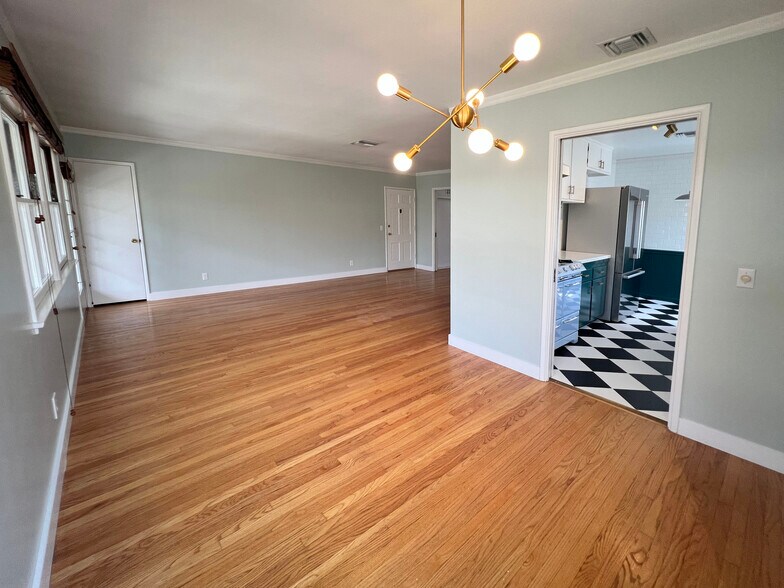 Dining area, living room on right, kitchen on left. Sputnik style brass chandelier. - 1327 N Central Ave