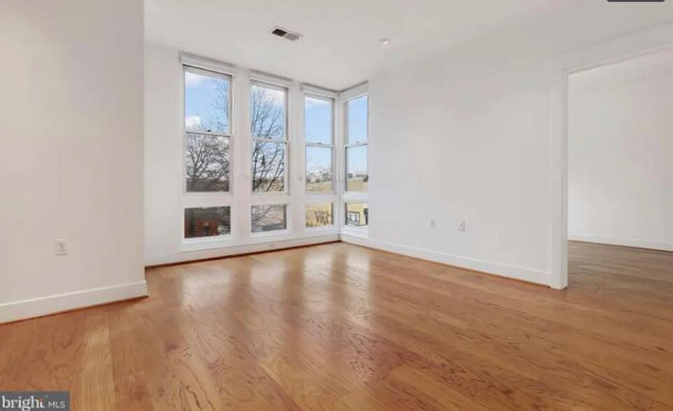 The gigantic floor to ceiling windows, let in gorgeous light throughout the unit. - 2910 Georgia Ave NW