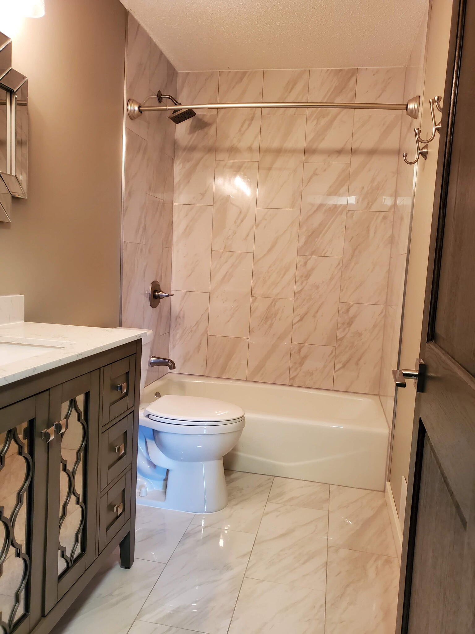 Bathroom has been completely remodeled with new tile floors and shower surround. New vanity and light fixture. - 2525 Cedar Hills Drive