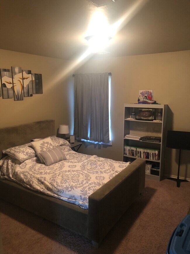 Guest bedroom. Full-size bed with plenty of room to move around. French door-style closet. - 2327 Austrian Pine Dr