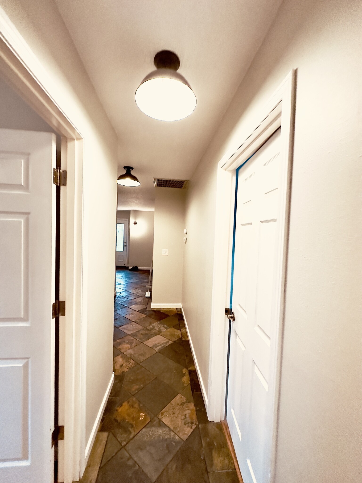 Hall looking towards foyer/front door. Master bedroom door on left, bonus room on right - 8717 NE Webster St