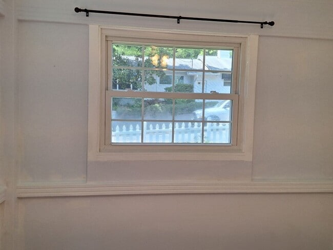 Building Photo - Cute white cottage with white picket fence & Huge deck off back door!