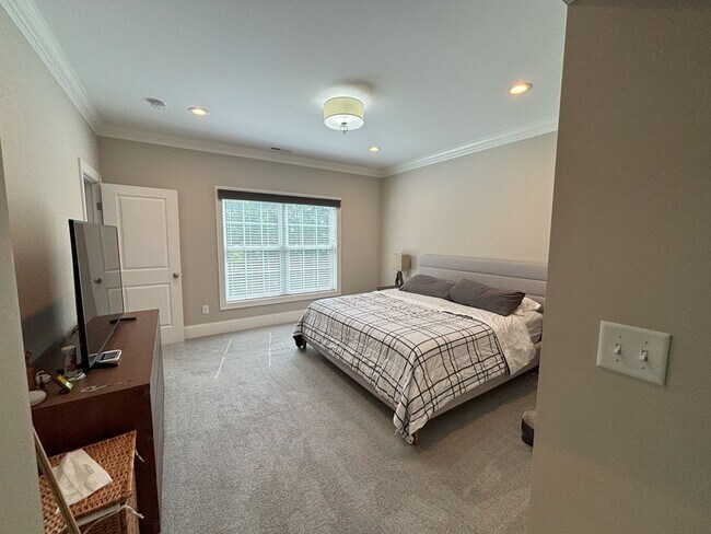 Main floor, main bedroom suite with walk in closet and full bathroom attached. Carpet flooring. - 140 Wells View Rd