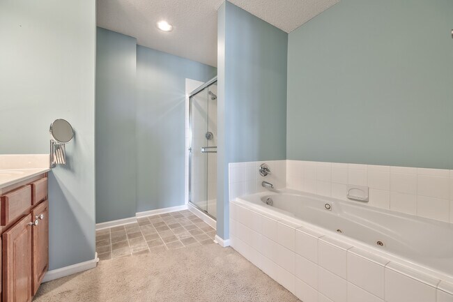 main bath with soaker tub and shower - 22613 W 72nd Ter