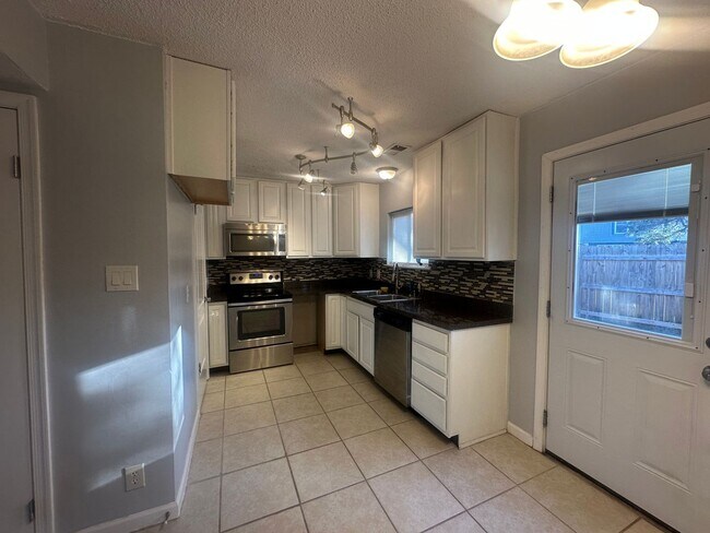 Building Photo - Centrally Located 2 BR Green Townhome with Fenced Patio