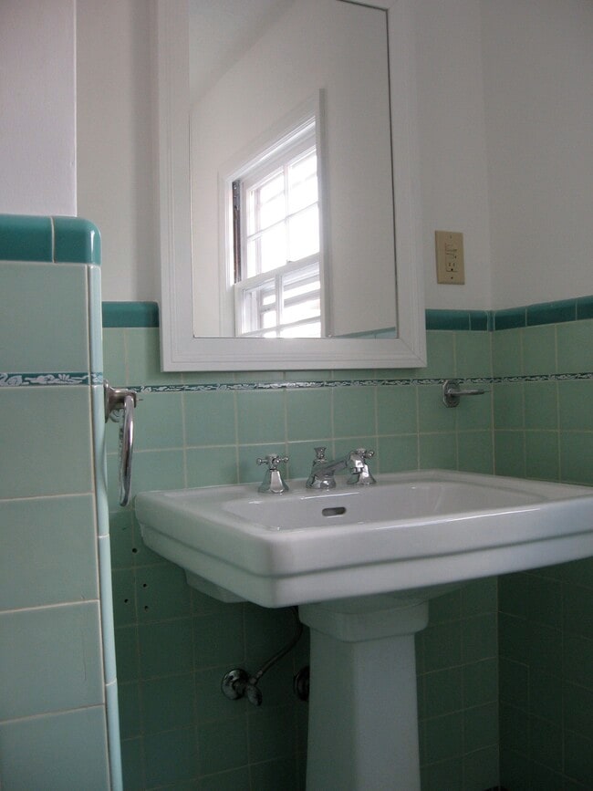 Upstairs bath with updated period fixtures. 2nd bath downstairs with unique wood and tile shower. - 2910 NE Mason