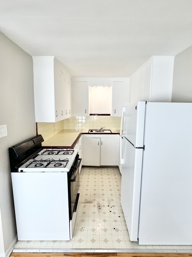 Explore this cozy kitchen, designed for functionality and convenience with stylish finishes. - The Birney Apartments