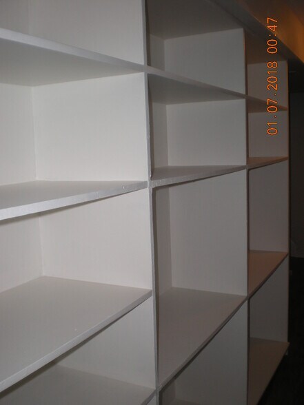 Wall of storage shelves in lower level hallway - 1160 Clinton St