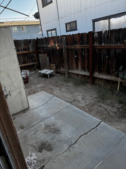 Backyard with laundry hookups - 635 W Olive Ave