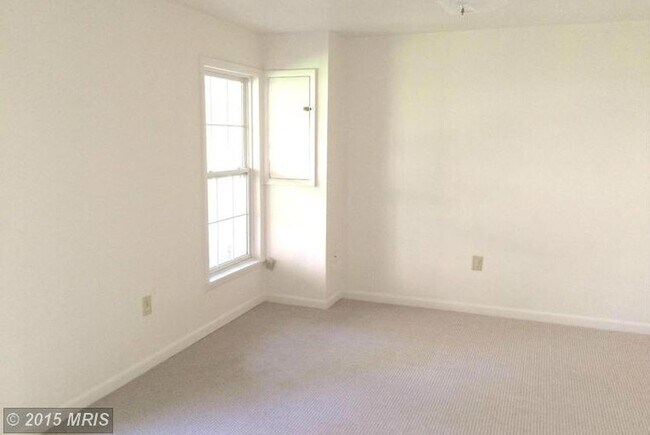 Building Photo - A spacious three bedroom, two and one half...