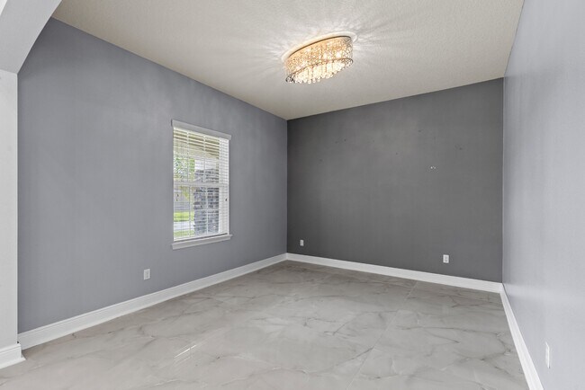 Building Photo - Spacious 6-Bedroom Home Near Lake Nona | 3-Car Garage + Tesla Charger