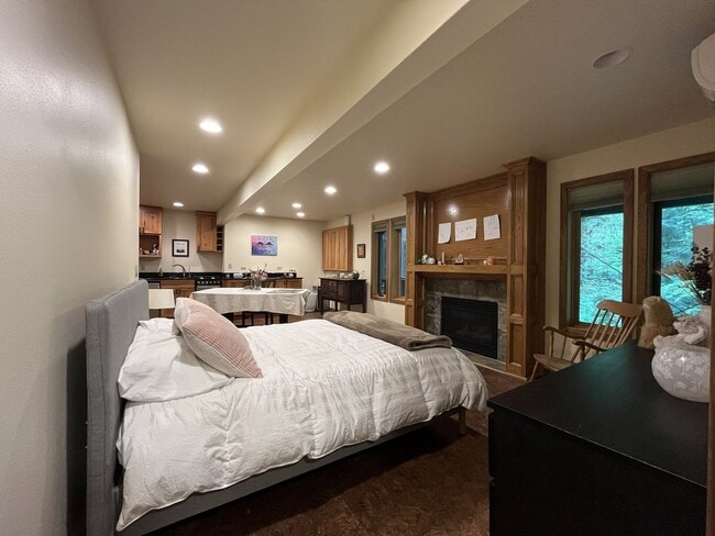 Building Photo - One-of-a-Kind Custom Home with Wall of Windows, Stone Fireplaces, Expansive Entertainment Space &...