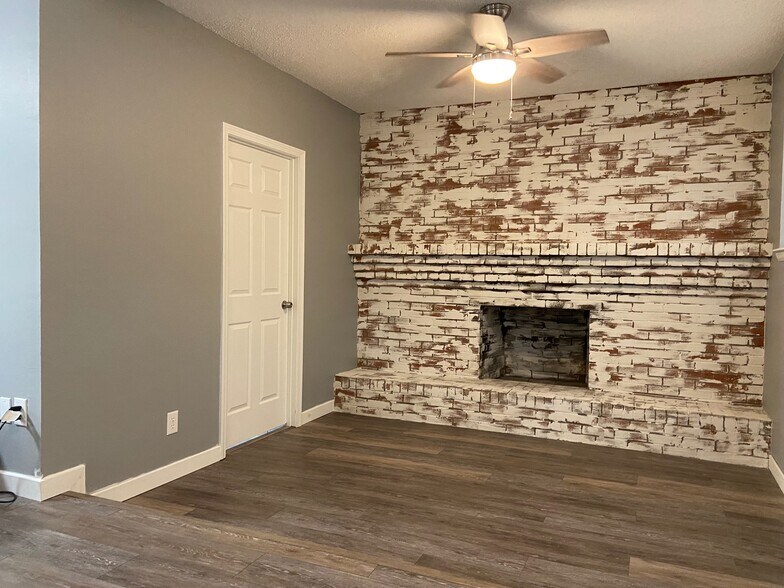 Living with the door to a bedroom with half bath - 101 Blaylock St