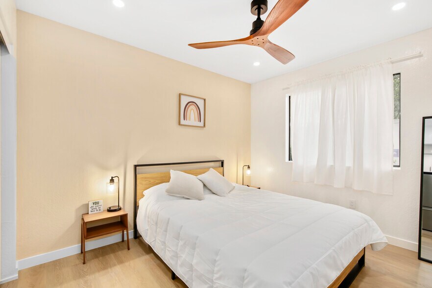 Stylish bedroom with modern fan, warm lighting, and cheerful décor. - 1013 S Sunshine Ave