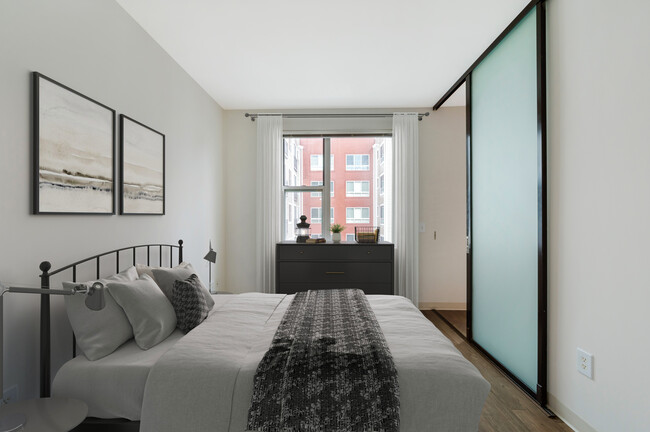 Bedroom with sliding barn door and hard surface flooring - AVA H Street