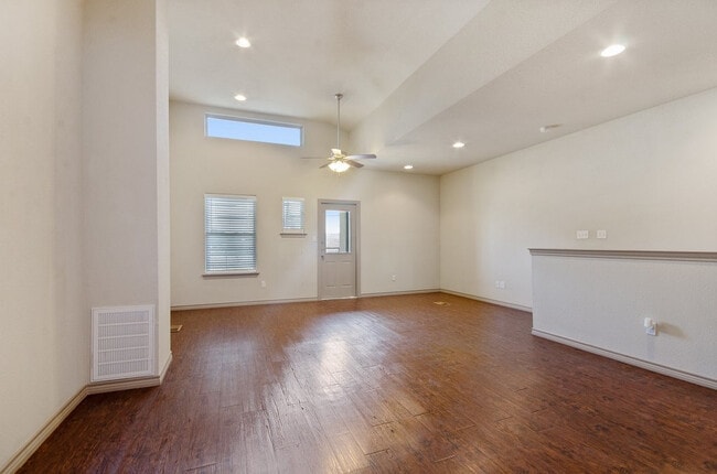 Entryway with vaulted ceiling, ceiling fan, and stairs down - Tinsley Place