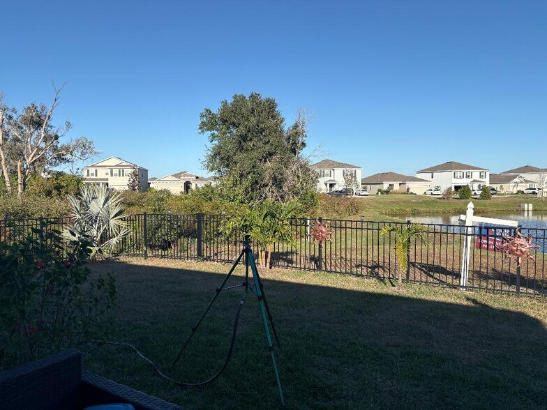 View of lake, conservation area and fence in back of house - 12404 Dora Trl