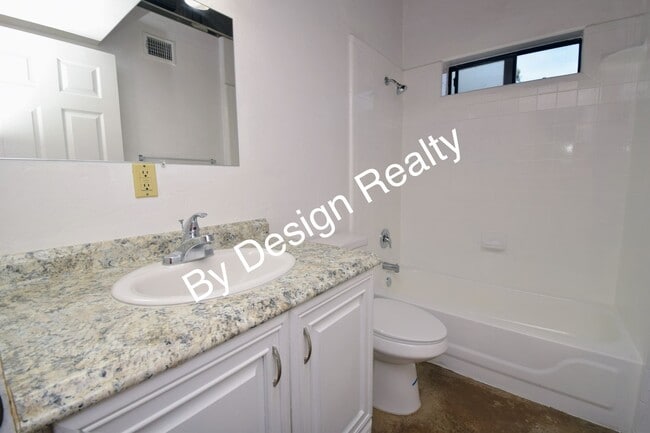 Building Photo - Charming Mid-Century Style: Vaulted Beams & Private Oversized Yard